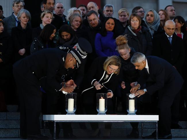 London Mayor Sadiq Khan, British Home Secretary Amber Rudd and Acting Commissioner of the Metropolitan Police Service Craig Mackey light candles. Picture: AFP/Adrian Dennis