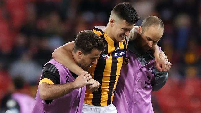 Young Hawk Mitch Lewis is helped from the ground during Sunday night’s match against GWS. Picture: Mark Kolbe/Getty Images