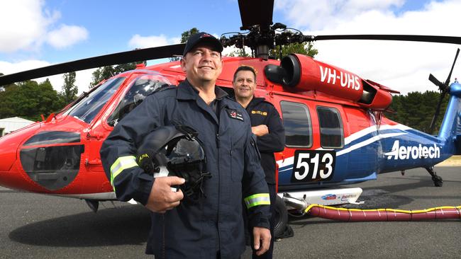 Pilot Scott Summers (Aerotech type specialist) and Nik Stanley (manager of aviation operations CFS) with one of the Black Hawk helicopters that will be used by the CFS to fight bushfires. Picture: Tricia Watkinson