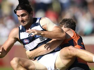 CANBERRA, AUSTRALIAN CAPITAL TERRITORY - APRIL 03: Shane Kersten of the Cats is tackled by Heath Shaw of the Giants during the round two AFL match between the Greater Western Sydney Giants and the Geelong Cats at Star Track Oval on April 3, 2016 in Canberra, Australia. (Photo by Brett Hemmings/AFL Media/Getty Images)