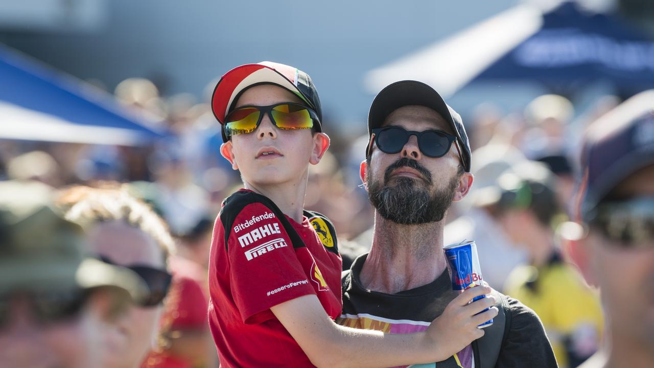 Charlie Kelly and dad Michael Kelly watch Red Bull pilot Matt Hall in the sky as V8 Supercars team Red Bull Ampol Racing launch 2024 livery at Toowoomba Wellcamp Airport, Saturday, February 3, 2024. Picture: Kevin Farmer