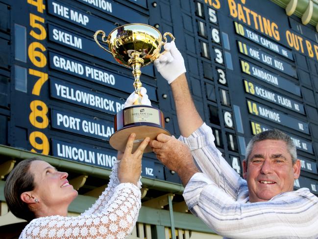 Adelaide Cup Barrier Draw on the Adelaide Oval Scoreboard. Joint trainers of The Map, the favourite in  the Adelaide Cup, with the cup in front of the barrier draw on the Adelaide scoreboard. 8 March 2024. Pic. Dean Martin