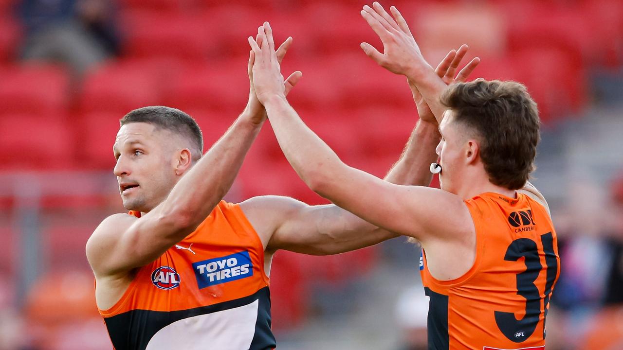 SYDNEY, AUSTRALIA - JULY 20: Jesse Hogan of the Giants celebrates a goal with teammate Toby McMullin during the 2024 AFL Round 19 match between the GWS GIANTS and the Gold Coast Suns at ENGIE Stadium on July 20, 2024 in Sydney, Australia. (Photo by Dylan Burns/AFL Photos via Getty Images)