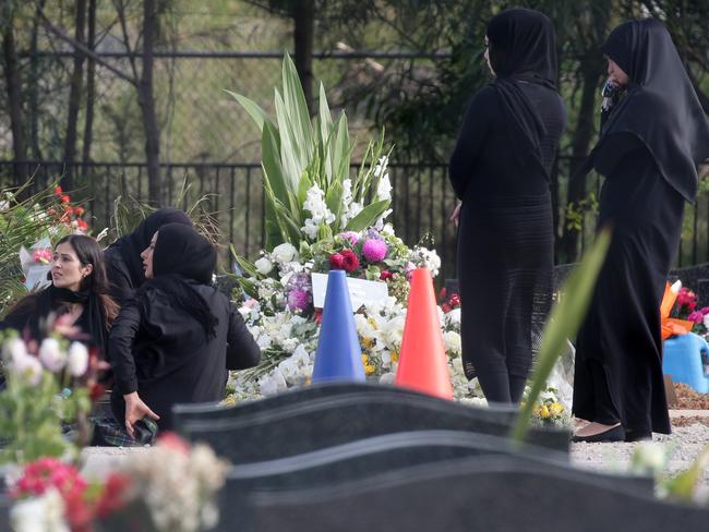 After the proceedings, the burial plot was covered with flowers.