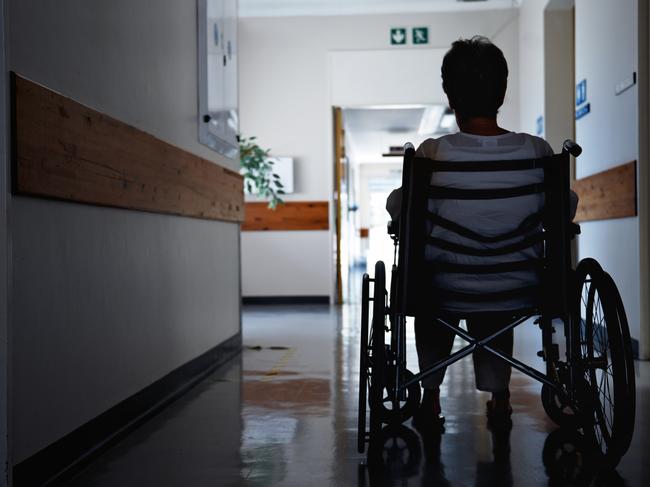 BAD AGED CARE:   Rearview shot of a senior woman sitting in a wheelchair