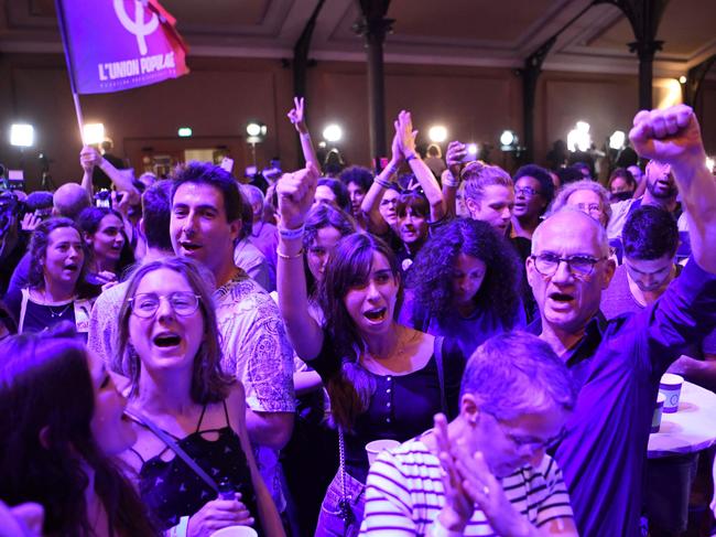 Supporters of left-wing coalition NUPES react after the first results of the parliamentary elections in Paris. Picture: Bertrand Guay / AFP