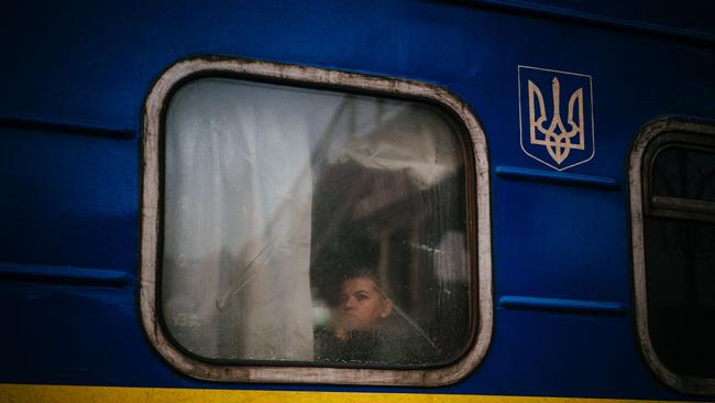 A woman looks out through the window of an evacuation train in the city of Kherson on December 30. Picture: Dimitar Dilkoff / AFP