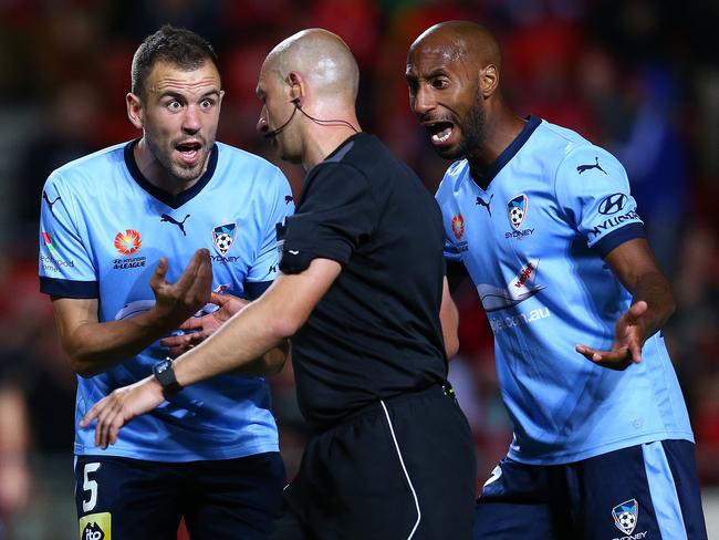 Sydney players Matthewe Jurman (L) and Mickael Tavares plead with referee Strebre Delovski. Picture: Sarah Reed.