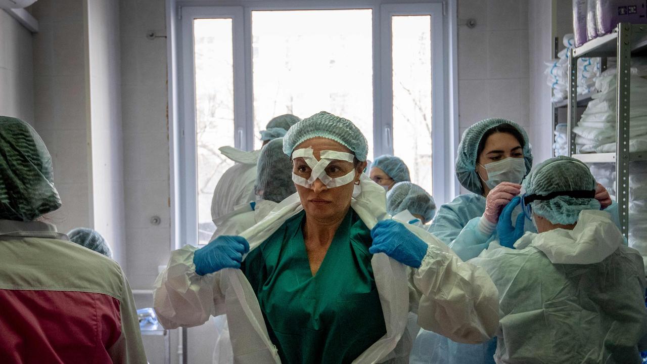 Medical workers get ready for a shift treating coronavirus patients at the Spasokukotsky clinical hospital in Moscow. Picture: Yuri Kadobnov/AFP