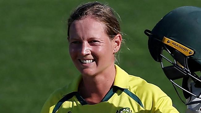 (FILES) In this file photo taken on March 22, 2022 Australia's captain Meg Lanning celebrates after reaching her century (100 runs) during the Women's Cricket World Cup match between Australia and South Africa at the Basin Reserve in Wellington on March 22, 2022. - Waiting tables in her local cafe and hanging out with friends and family helped rekindle Meg Lanning's love of cricket and intensified her drive to steer top-ranked Australia to another Twenty20 World Cup title this month.The decorated women's skipper took a indefinite months-long hiatus in 2022 after an intense few years, sparking fears she would not return. (Photo by Marty MELVILLE / AFP)