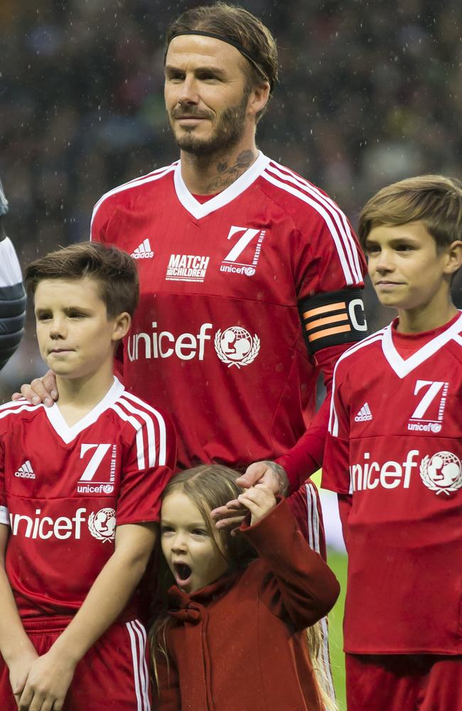 David Beckham, stands with his children before the Unicef Match for Children charity football match between a Great Britain and Ireland team and a Rest of the World team at Old Trafford Stadium, Manchester. Picture: AP