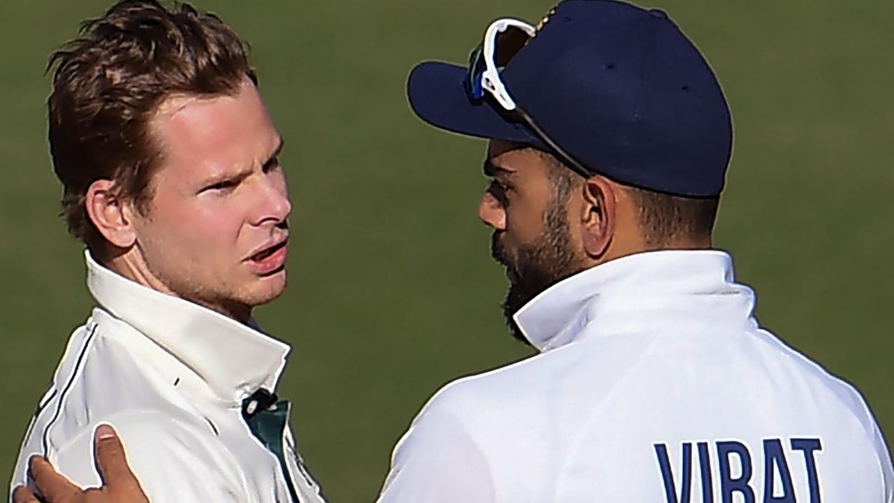 Australia's Steve Smith (L) talks with India's Virat Kohli on the third day of the first cricket Test match between Australia and India in Adelaide on December 19, 2020. (Photo by William WEST / AFP) / --IMAGE RESTRICTED TO EDITORIAL USE - NO COMMERCIAL USE--