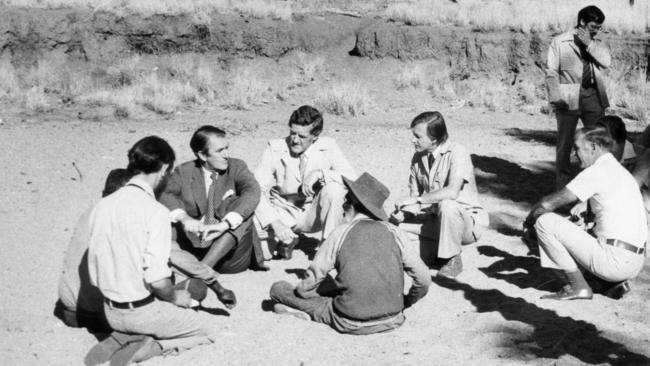 Aust Prime Minister Malcolm Fraser sitting on the Todd River bed during a four-day tour of Aboriginal settlements in the Northern Territory, 24-27 Apr 1978. Aboriginal leader Bluey Jabarula, with his back to the camera, talks to Mr. Fraser. Charles Perkins, Minister for Aboriginal Affairs Ian Viner (right of Bluey), and others. Picture: File