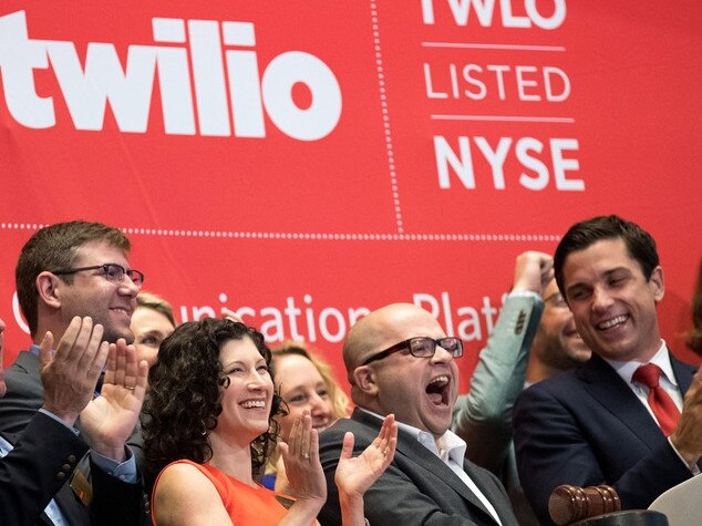 Jeff Lawson, Twilio’s founder and chief executive, in middle with glasses, reacts after ringing the opening bell when the cloud-computing company went public in June 2016. Twilio has two classes of stock. PHOTO: GETTY IMAGES