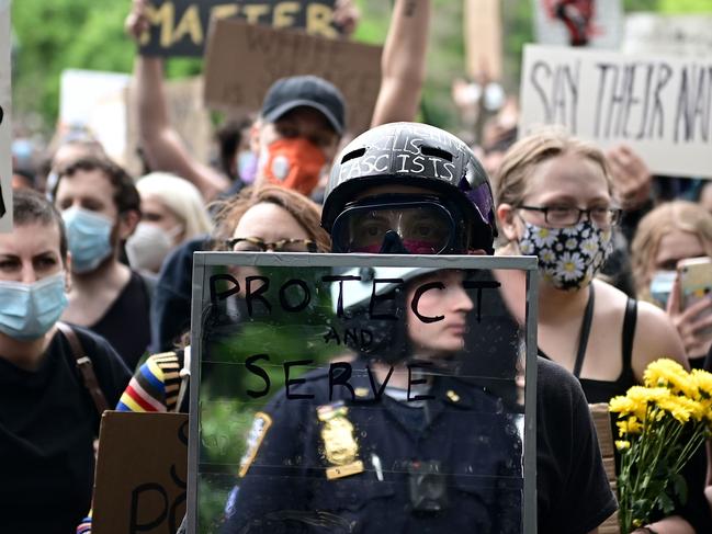 A protester holds a mirror up to police during a Black Lives Matter protest in New York. Picture: AFP