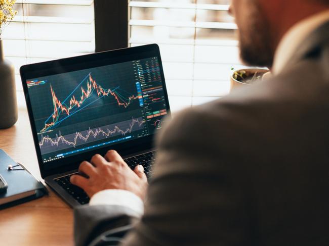 Businessman checking stock market chart on laptop. Trading app on device screen. Fund manager looking at stock market chart. Businessman making money as crypto trader investor broker. Young man at the office trading Online Using laptop. TradingView  Picture: istock