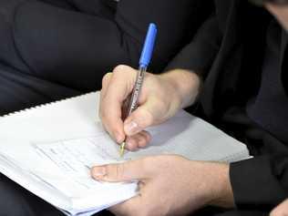 A woman writing on a note pad. Picture: Bev Lacey