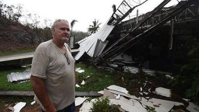 Dave McInerney beside the wreckage of his business at Shute Harbour.