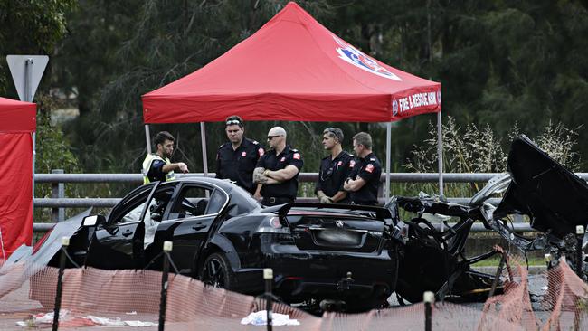 Emergency crews look at the carnage. Picture: Adam Yip/Second Story