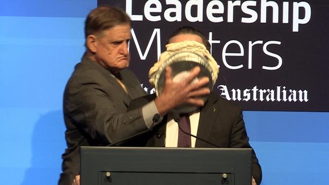 Qantas CEO Alan Joyce comes under pie attack in Perth on Monday.