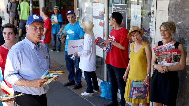 Politicians hit the campaign trail in the federal seat of Bennelong ahead of the by-election vote this Saturday. Liberal member John Alexander and Labor member Kristina Keneally hand out flyers outside the pre polling office in Epping. Picture: Toby Zerna