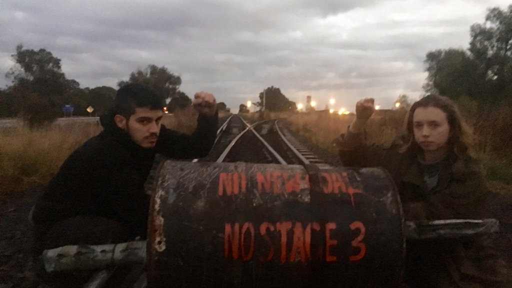 Pinheiro and Dorge from Front Line Action on Coal Brisbane chained themselves to a concrete barrel on the rail line at Jondaryan. Picture: Contributed