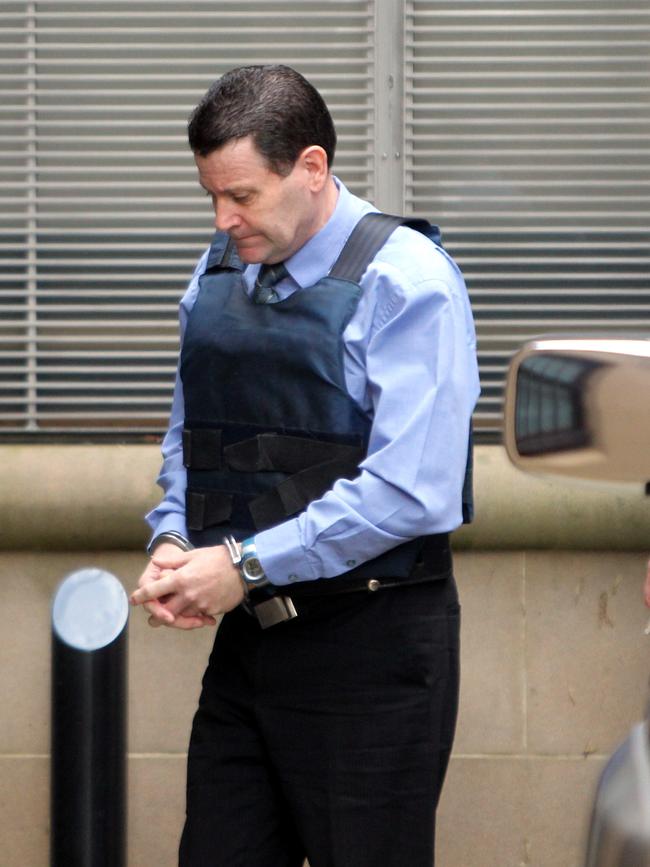 One of Australia’s biggest ever rats in the law enforcement ranks, NSW Crime Commission assistant director Mark Standen being led into King Street Court in the Sydney CBD after being convicted of conspiring a mass drugs shipment. Picture: News Corp