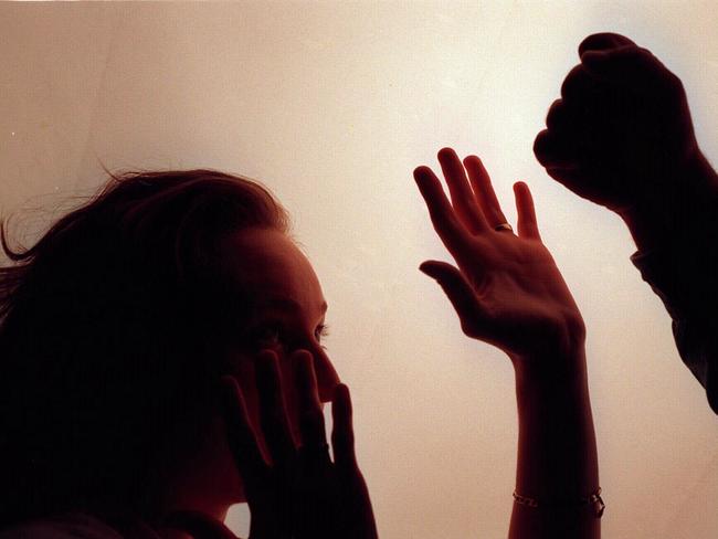 Domestic violence silhouette generic image - fist raised against woman./Violence