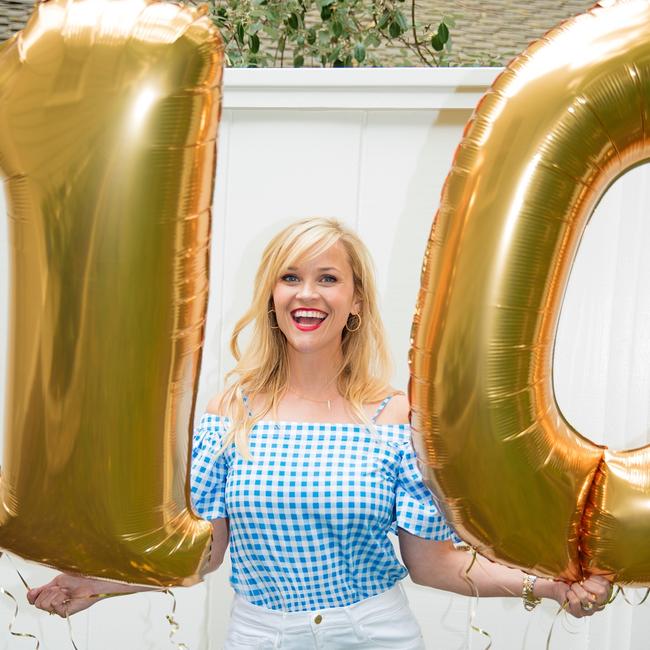 Reese Witherspoon gets out her best gingham top to celebrate... 
