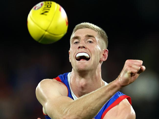 MELBOURNE, AUSTRALIA - APRIL 12: Tim English of the Bulldogs handballs during the round five AFL match between Western Bulldogs and Essendon Bombers at Marvel Stadium, on April 12, 2024, in Melbourne, Australia. (Photo by Quinn Rooney/Getty Images)