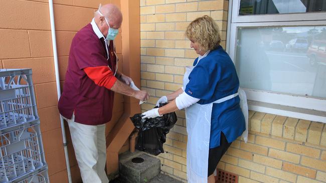 CLEAN UP: Dr Brian Rickard Veterinarian and his wife Marilyn, the practice manager at Nobby Beach Veterinary Clinic, sterilise the front of the clinic Picture: Mike Batterham