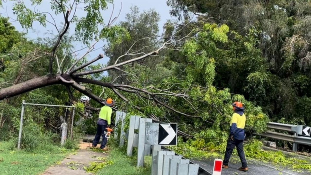 Rockhampton Regional Council workers clear a fallen tree from the High Street Bridge on January 19 following a violent storm.