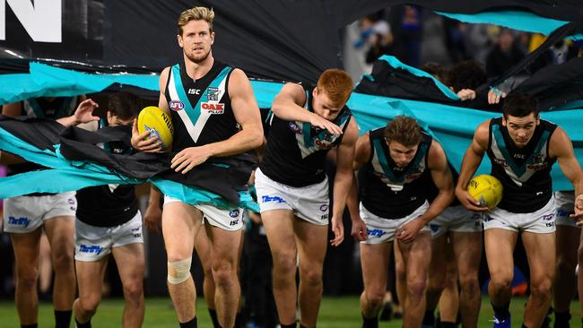 Tom Jonas leads Port Adelaide through the banner against West Coast on Friday. Picture: Daniel Carson (Getty).