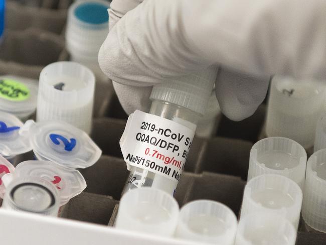 (FILES) In this file photo Dr. Nita Patel, Director of Antibody discovery and Vaccine development, lifts a vial with a potential coronavirus, COVID-19, vaccine at Novavax labs in Gaithersburg, Maryland on March 20, 2020, one of the labs developing a vaccine for the coronavirus, COVID-19. - The Canadian government announced on August 31, 2020 a deal with American biotech firm Novavax for 76 million doses of its Covid-19 vaccine in development, if it proves to be effective against the new coronavirus. The NVX-CoV2373 vaccine candidate, which is currently in Phase 2 clinical trials to evaluate its safety and immunogenicity, could be delivered in the second quarter of 2021, Ottawa and the company said in a joint statement. Procurement Minister Anita Anand said the deal "will give Canadians access to a promising COVID-19 vaccine candidate." (Photo by ANDREW CABALLERO-REYNOLDS / AFP)