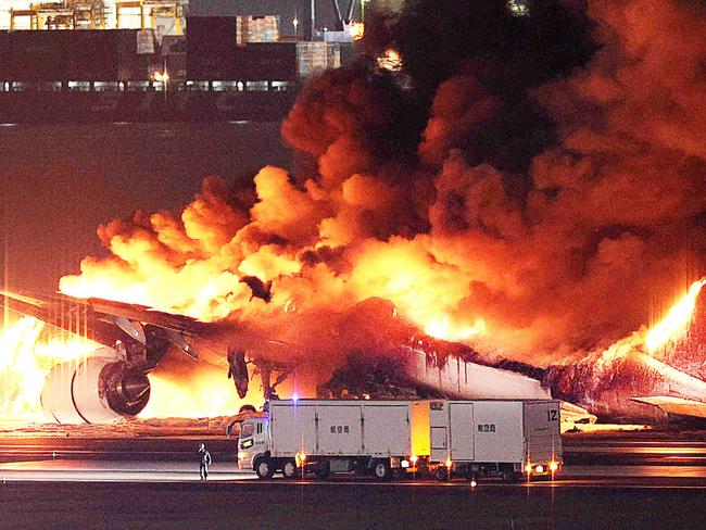 TOPSHOT - This photo provided by Jiji Press shows a Japan Airlines plane on fire on a runway of Tokyo's Haneda Airport on January 2, 2024. A Japan Airlines plane was in flames on the runway of Tokyo's Haneda Airport on January 2 after apparently colliding with a coast guard aircraft, media reports said. (Photo by JIJI PRESS / AFP) / Japan OUT