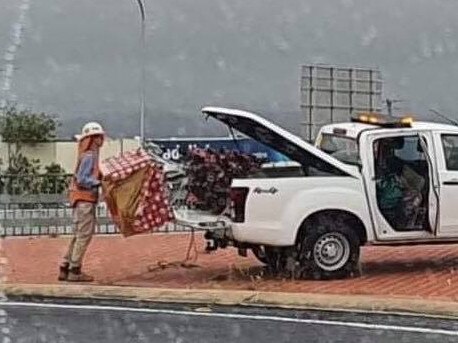 TMR packing up the Christmas tree that was placed by the tinsel bombers at the Oxenford overpass. Photo supplied by Gold Coast Community Facebook Page.