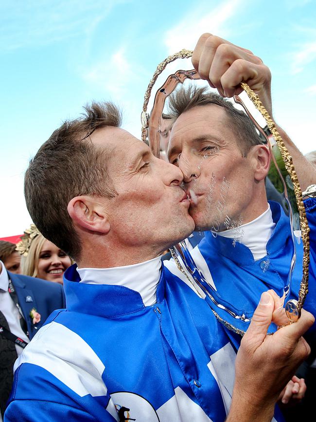 Jockey Hugh Bowman kisses the Cox Plate after winning for a third straight time on Winx. Picture: Ian Currie