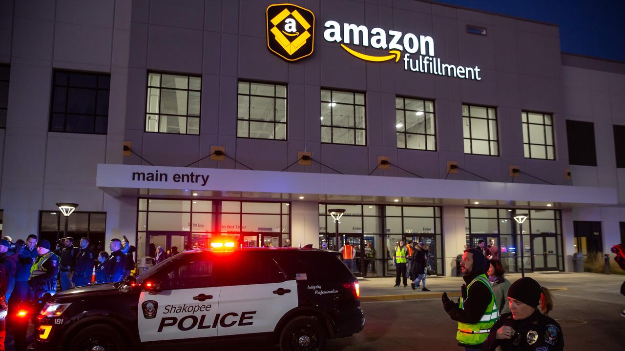 Police guarding an Amazon fulfilment centre from protesters in 2018. Picture: Kerem Yucel / AFP