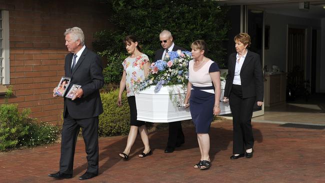 The joint casket of Khandalyce Pearce and Karlie Pearce-Stevenson is walked to the hearse prior to their funeral.