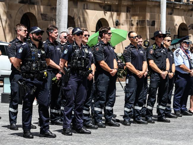 Members of the Queensland police service and other emergency services watch the Queensland Police Memorial Service for Constable Rachel McCrow and Constable Matthew Arnold from King George Square. Picture: Zak Simmonds