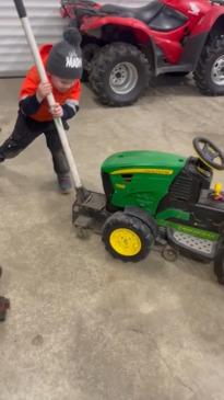 Little boy shows off his car mechanic skills