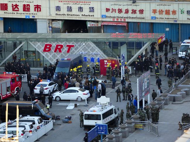 Security personnel gather near the scene of an explosion outside the Urumqi South Railway Station. AP Photo.