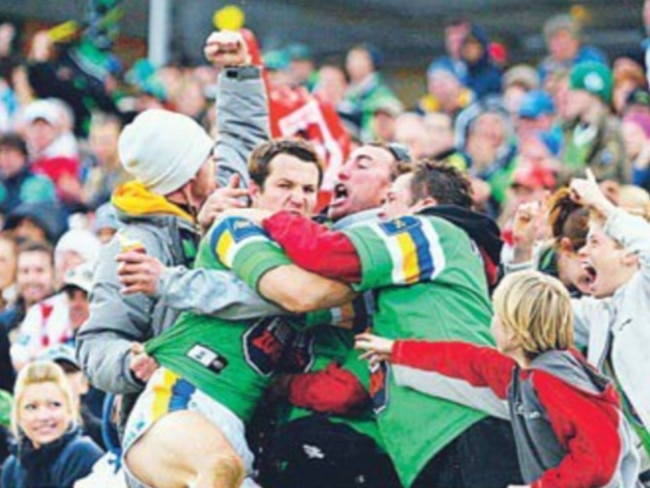 Raiders player Clinton Schifcofske embracing fan Peter Osborne after setting up the winning try in 2006. Picture: The Canberra Times.