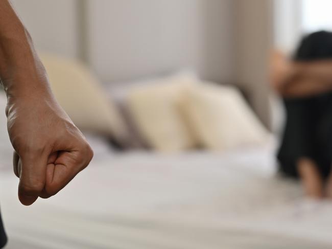 istock generic:  woman, abuse, DV, domestic violence, harassment, sexual harassment.   Selective focus on the fist male with crying man sits on a bed as the background, Violence, Love and relationships, Gay couple, sexual harassment concept. . Picture: istock