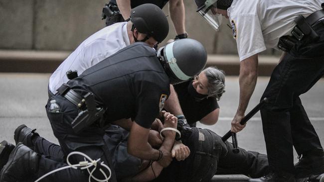 Police arrest a protester refusing to get off the streets during a curfew in New York. Picture: AP