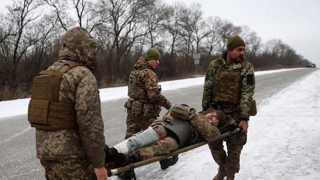 Ukraine army medics evacuate a wounded soldier on a road not far of Soledar, Donetsk region on January 14. Picture: AFP