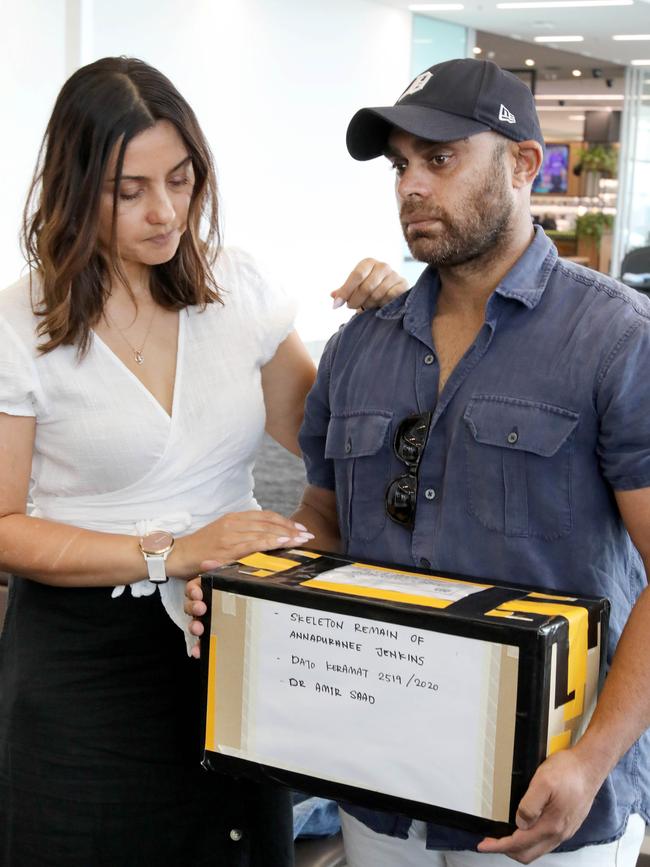 Jen Bowen with brother Greg Jenkins arriving at Adelaide Airport carrying Anna’s remains in a cardboard box.