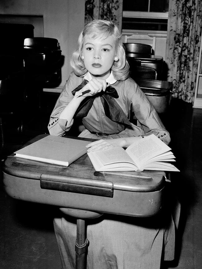 A 14-year-old Sandra Dee sits at a school desk on the set of Until They Sail, in Hollywood, California, in 1957.