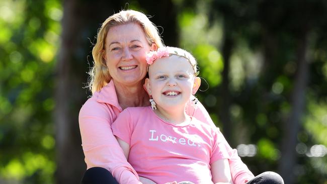 Sophia Allen, 9, with her great aunt Vicky Graham, who is raising money for her treatment by competing in a half Ironman. Picture: Liam Kidston.