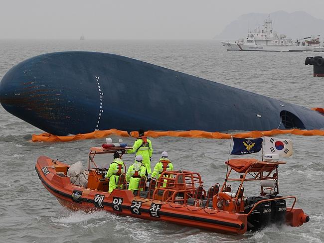 Scrambling to find more alive ... South Korean Coast Guard and rescue teams search as bad weather hampers their attempts. Picture: Chung Sung-Jun.